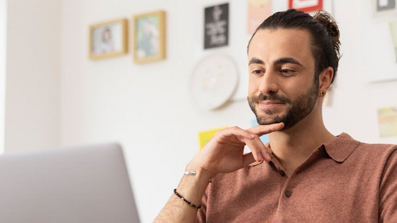 Uomo che guarda il computer portatile per ottenere informazioni